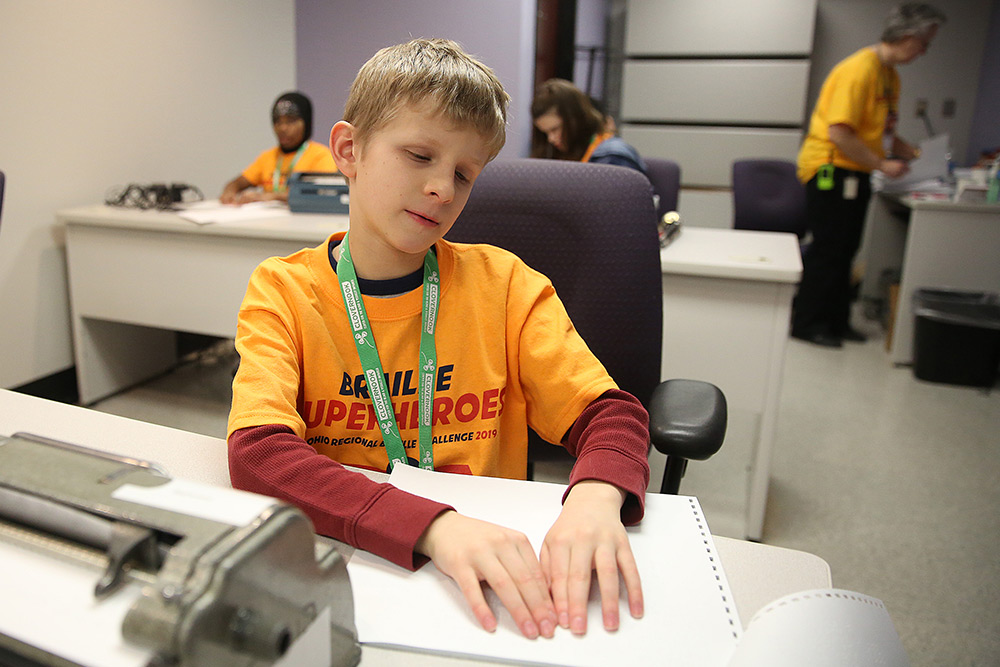 A young man competes in one of the challenges at the Ohio Regional Braille Challenge in 2019.