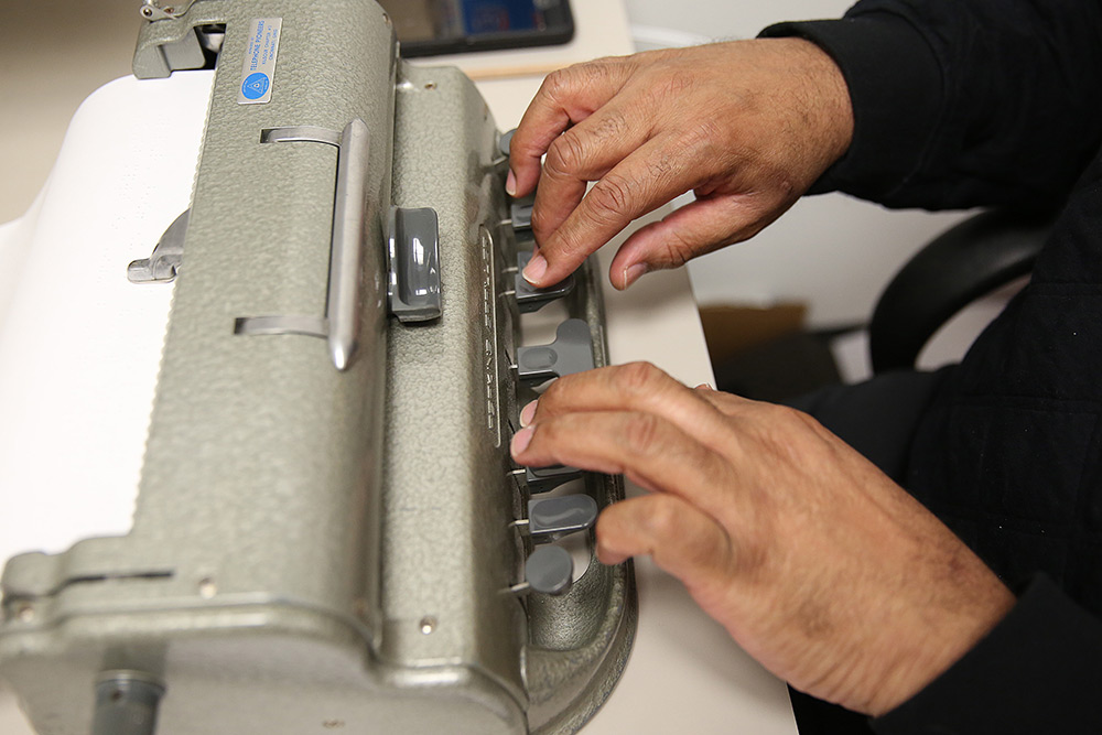 person transcribing NLS Technical Braille at Clovernook Center 