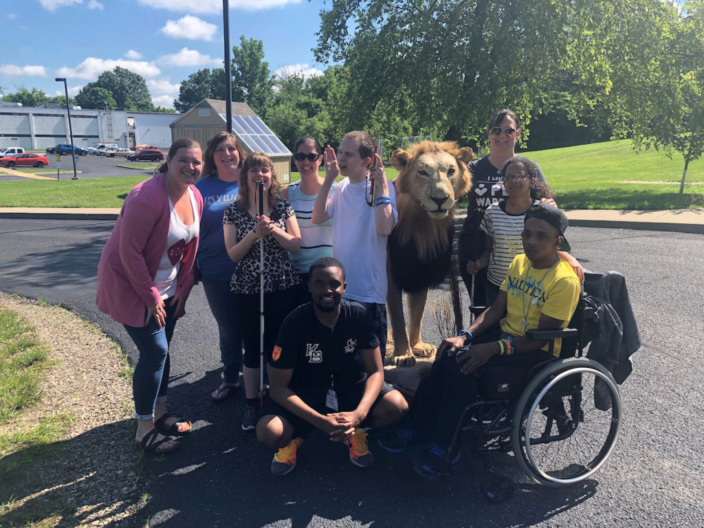 Senior summer camp participants enjoy a traveling petting zoo to get a hands-on experience of learning about animals.
