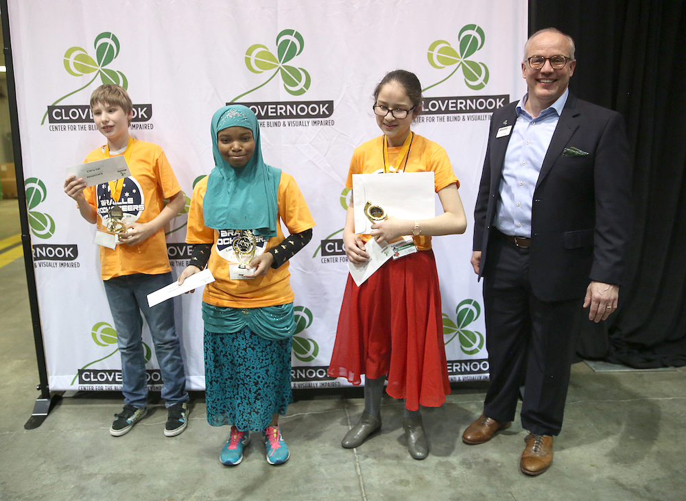 Three winners receive their prizes from Clovernook Center officials.